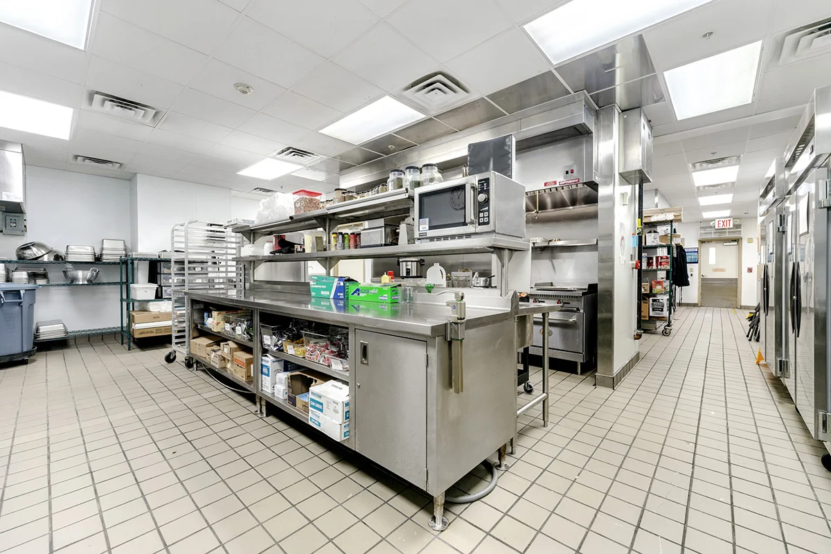 a large commercial kitchen with stainless steel appliances