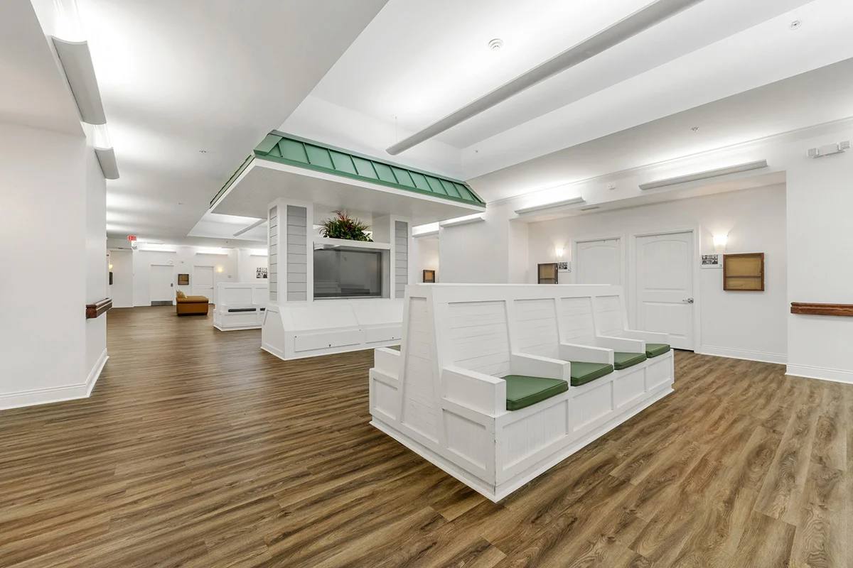 a room with white benches and wood floors