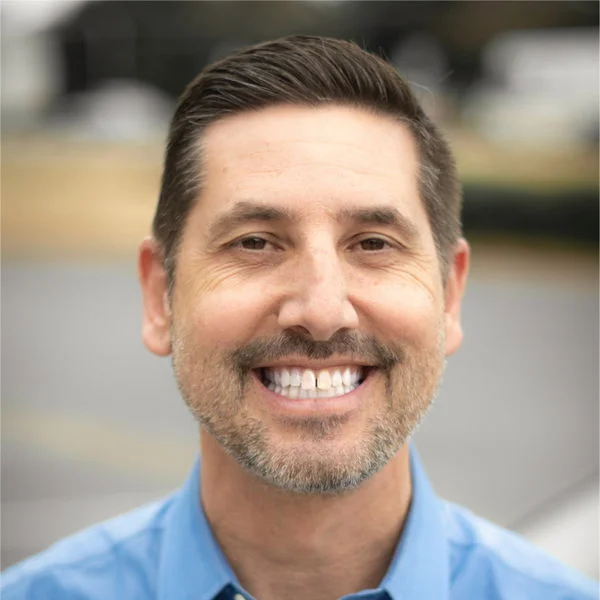 a man smiling at the camera